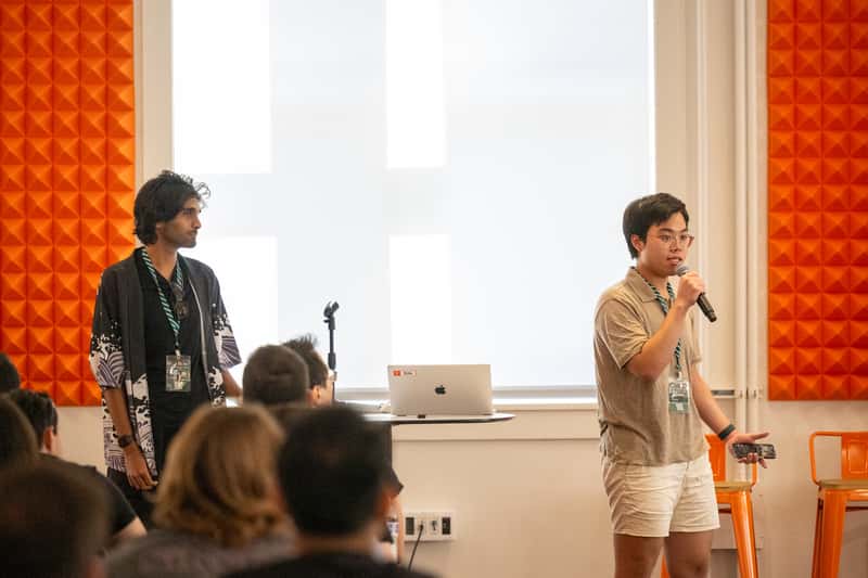 Mark Rachapoom and Kumar Abhirup presenting at Y Combinator